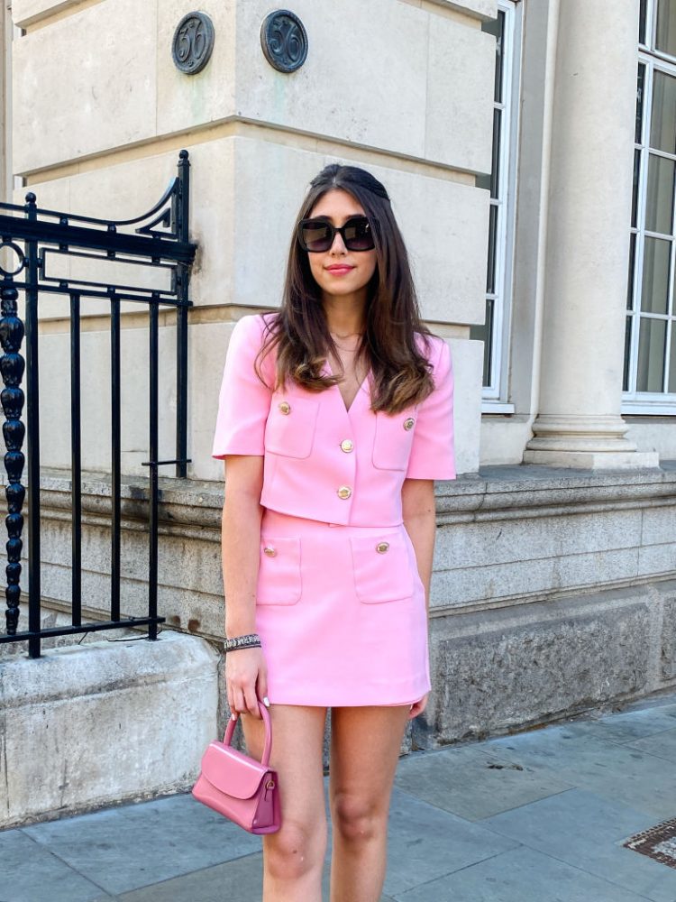 PARIS, FRANCE - MAY 31: Bianca Derhy wears sunglasses, a pink blazer jacket from Zara, a Zara short mini pink skirt, a pink bag from By Far, during an online remote fashion photo session via Apple iphone / Facetime and the CLOS app as the model is based in London - England and the photographer in Paris - France, on May 31, 2021 in Paris, France. (Photo by Edward Berthelot/Getty Images)
