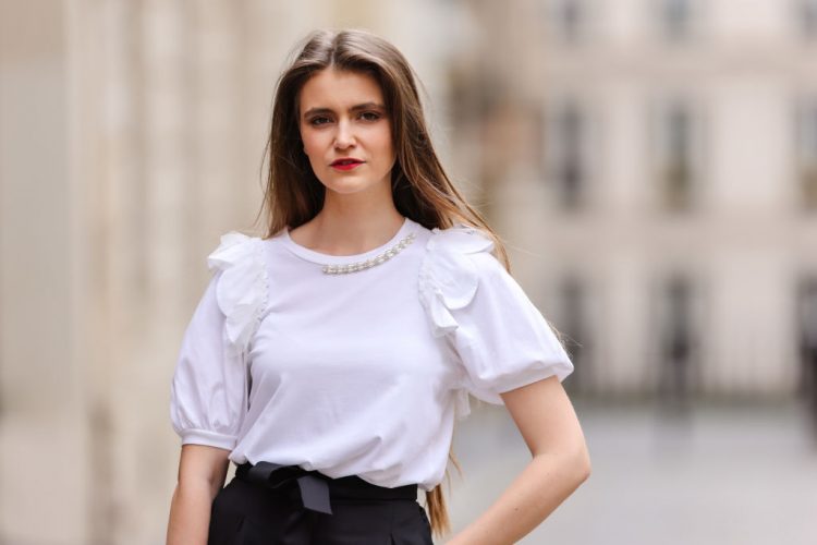 PARIS, FRANCE - MAY 20: Fashion blogger @hippolyt.e wears a white t-shirt/top with pearls detail on the collar and puffy sleeves from Simone Rocha, black knotted belted carrot pants from Maje, on May 20, 2021 in Paris, France. (Photo by Edward Berthelot/Getty Images)