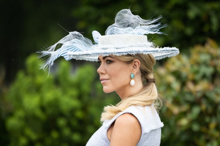 ASCOT, ENGLAND - JUNE 17: A race-goer shows off her hat after arriving at Ascot Racecourse on June 17, 2021 in Ascot, England. Gold Cup Day at the annual Royal Ascot race meeting has been affectionately known as Ladies Day since 1823. Traditionally women were given free or discounted tickets to the event and wore their finest fashions. Although today the discounts have been discontinued there is still a dress code for women attending the meet showing off extravagant clothing and outlandish millinery. (Photo by Leon Neal/Getty Images)