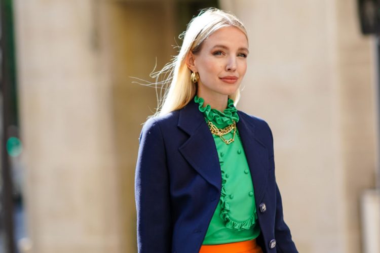 PARIS, FRANCE - JULY 12: Leonie Hanne wears golden earrings, a golden necklace, a dark navy blue Prada blazer jacket, a green ruffled silky Prada shirt with frilly collar, on July 12, 2020 in Paris, France. (Photo by Edward Berthelot/Getty Images)