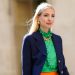 PARIS, FRANCE - JULY 12: Leonie Hanne wears golden earrings, a golden necklace, a dark navy blue Prada blazer jacket, a green ruffled silky Prada shirt with frilly collar, on July 12, 2020 in Paris, France. (Photo by Edward Berthelot/Getty Images)